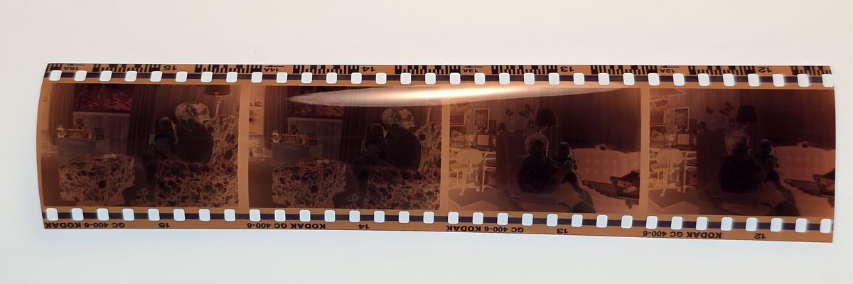 A strip of orange-brown 35mm color film negatives