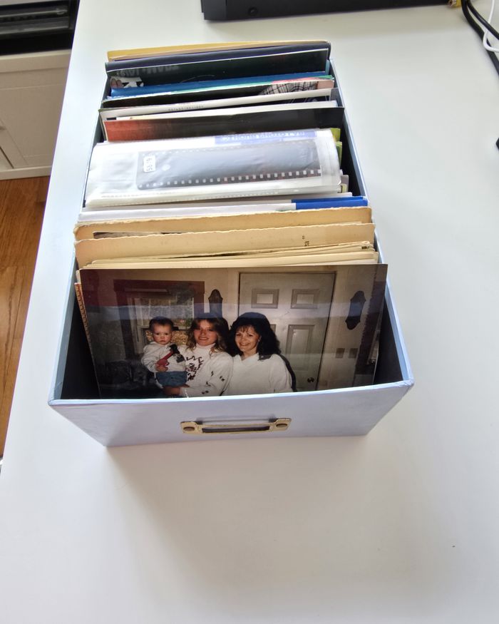 A photo storage box full of loose family prints