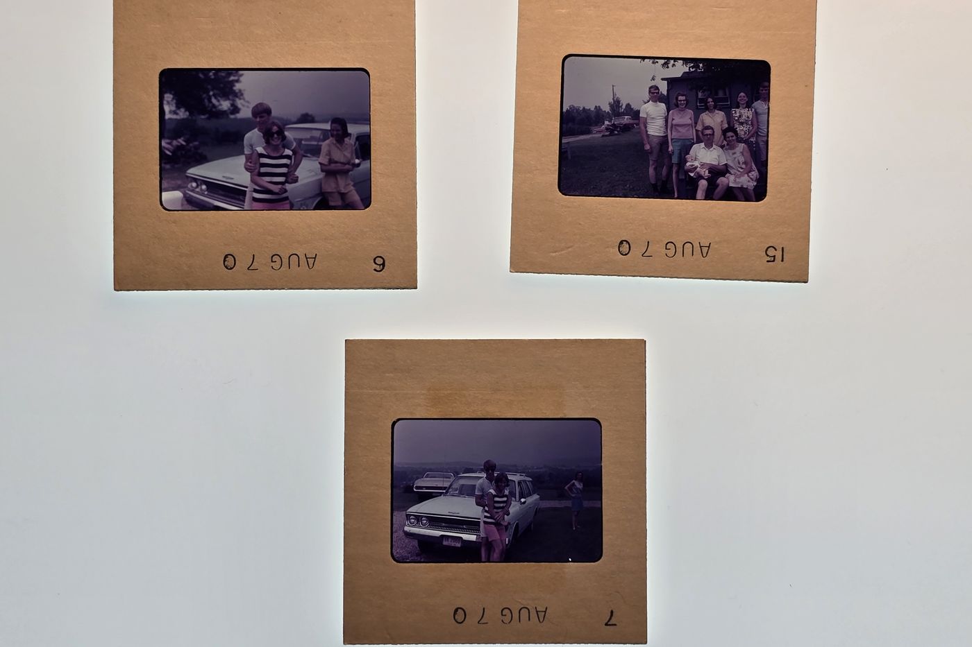 Three 35mm slides in cardboard mounts stamped AUG 70, showing family photos